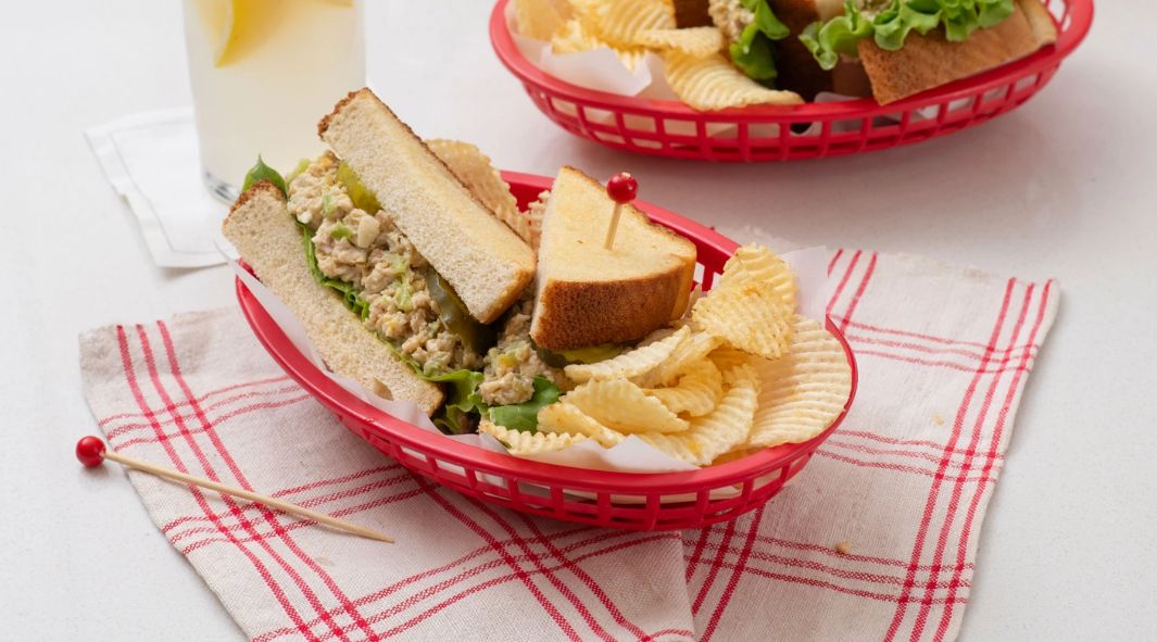 Chick-fil-A Chicken Salad on bread in a basket with chips, sitting on a napkin 