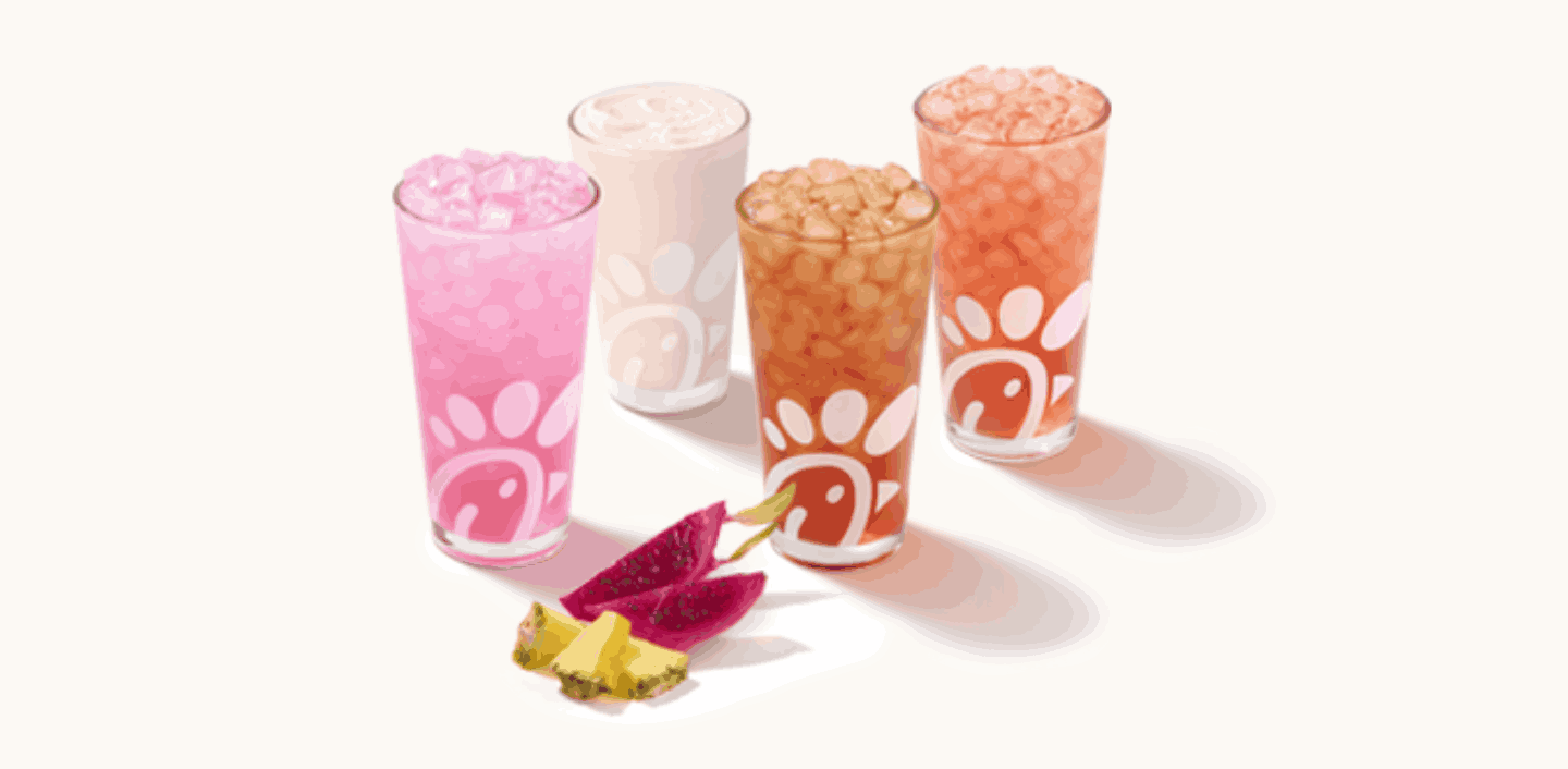 Angled photo of a glass of a Pineapple Dragonfruit Lemonade, Frosted Lemonade, Iced Tea and Sunjoy® on a cream background